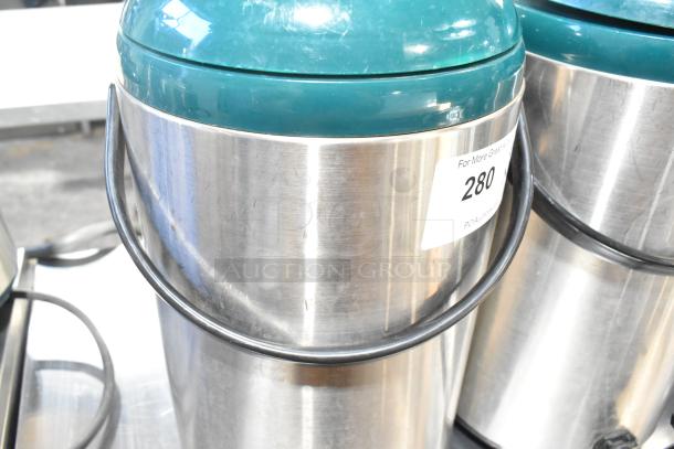 Two stainless steel beverage dispensers with teal tops, featuring a label "280." Slight surface wear visible.