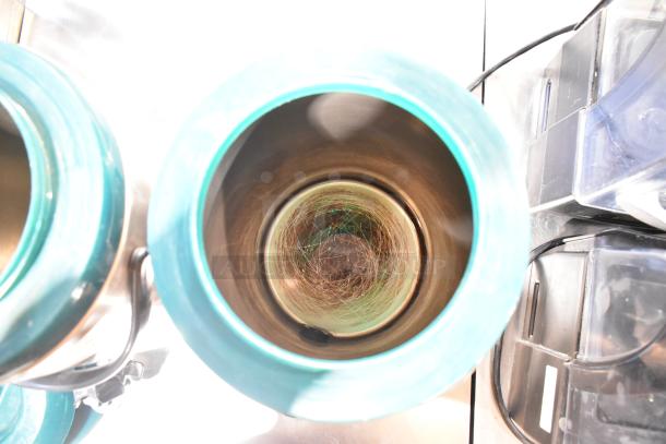 Set of 2 metal beverage holder dispensers, turquoise exterior, visible internal spirals, sturdy handles; excellent condition.