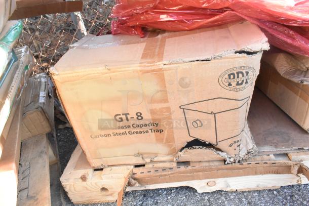 Cardboard box with GT-8 Carbon Steel Grease Trap. Box shows minor damage. Part of a lot with five additional new items.