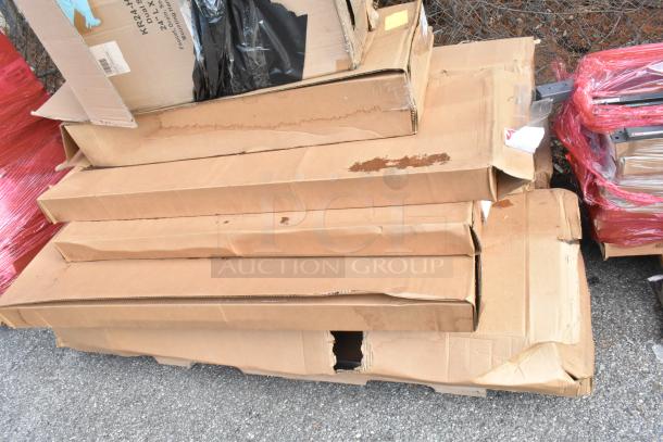 Stack of unopened boxes containing brand new Krowne KR24-HX18 Dual Sink, Metro MQ2148G Shelf, SC-72 Pot Rack.