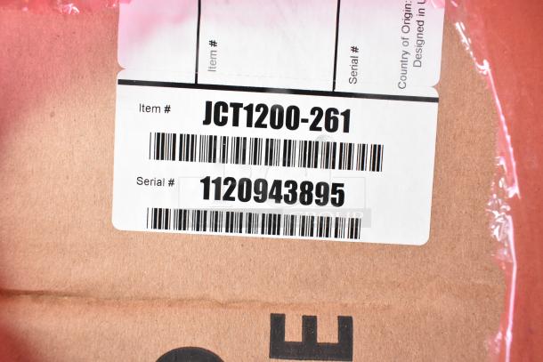 Barcoded label showing Manitowoc JCT1200-261 item number and serial number 1120943895 on packaging.
