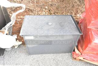 BRAND NEW SCRATCH AND DENT BK Resources BK-GT-10 grease trap, steel, diamond-patterned lid, slight surface imperfections, outdoor placement.
