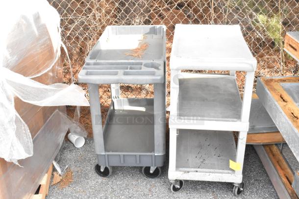 Two gray poly 3-tier carts with commercial casters, showing signs of light wear, ready for bids.