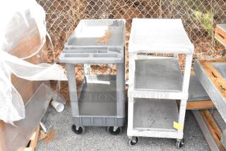 Two gray poly 3-tier carts with commercial casters, showing signs of light wear, ready for bids.