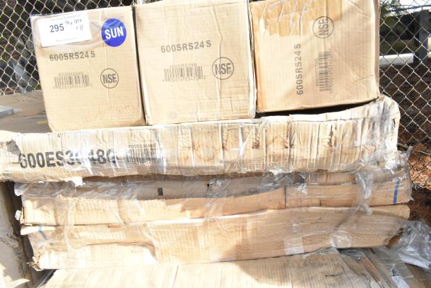 Image of stacked cardboard boxes labeled "600SRS24S" and "600ES3048G," showing signs of wear. Marked NSF, with auction tag.