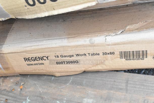 Cardboard box for Regency 18 Gauge Work Table, 30x60 inches, model 600T3060G, shows minor damage. Barcode visible.
