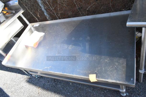 Stainless Steel Equipment Stand with under shelf and commercial casters. Visible wear and sticker on top.