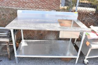 Stainless steel table with integrated sink bay, backsplash, and under shelf. Used condition with visible wear.