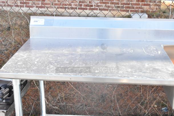 Stainless steel table with sink bay, back splash, and under shelf. Slight wear visible. Tag shows "298" quantity 1.