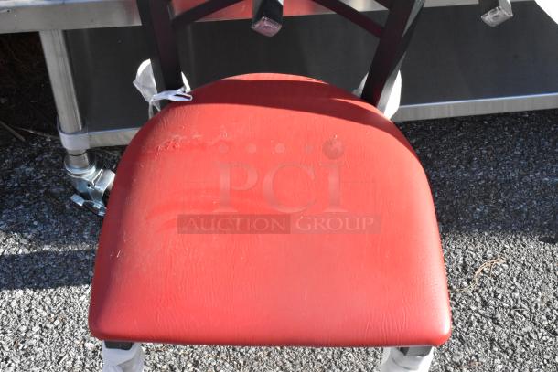 Black metal cross back dining chair with red seat cushion, moderate wear. Includes 3 chairs per bid.