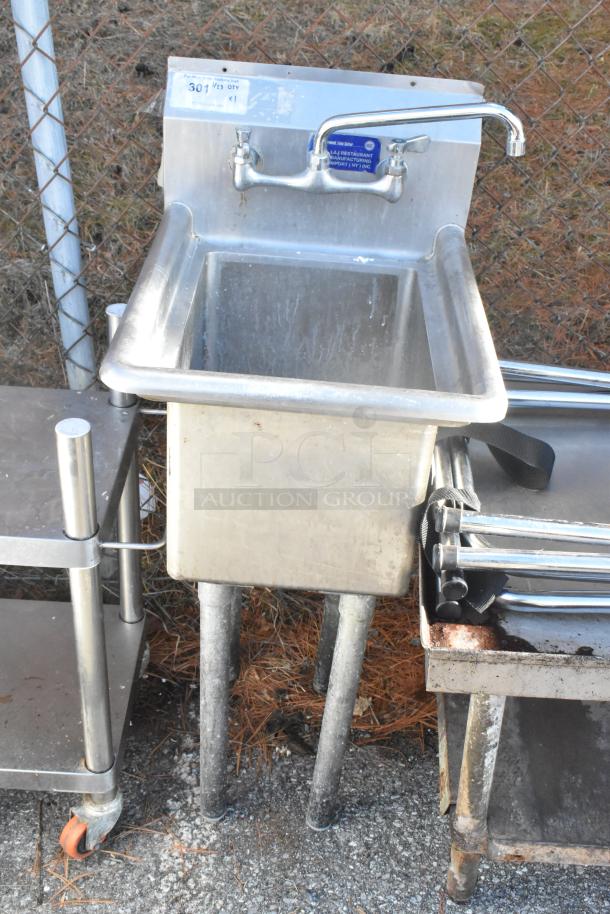 Stainless steel single bay sink with high-rise faucet, moderate wear. Markings indicate restaurant-grade manufacturing.