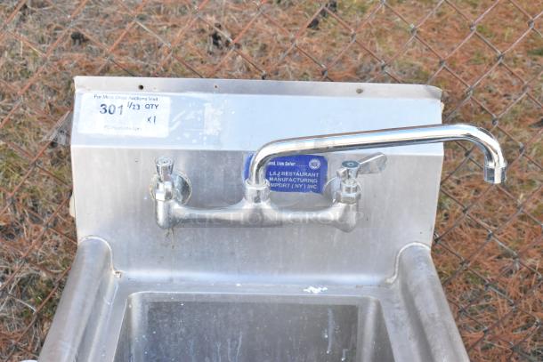 Stainless steel single bay sink with dual faucets, L&J Restaurant Manufacturing label, slightly worn condition.