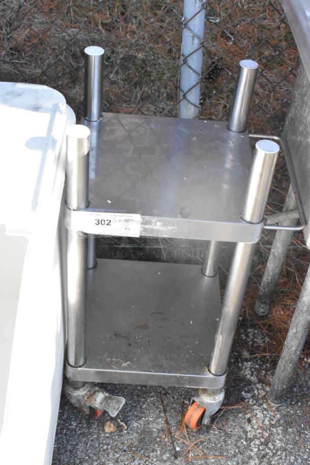 Stainless steel rice cooker equipment stand with under shelf and commercial casters. Visible tag: "302 QTY 1". Good condition.