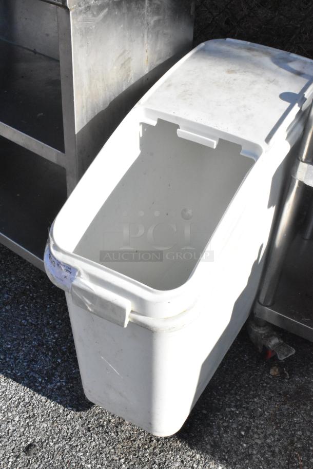 White poly ingredient bin on casters, open lid, showing interior. Visible wear, side label partially peeling.