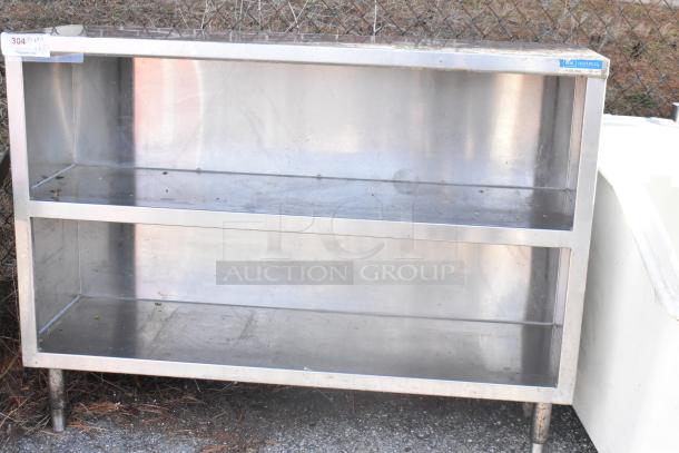 Stainless steel table with two under shelves; shows some wear. Ideal for storage. Labeled "LK Resources."