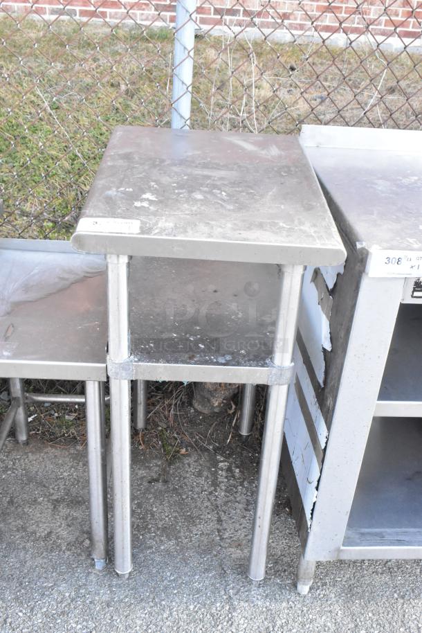 Stainless steel table with metal under shelf, shows signs of wear, suitable for industrial use.