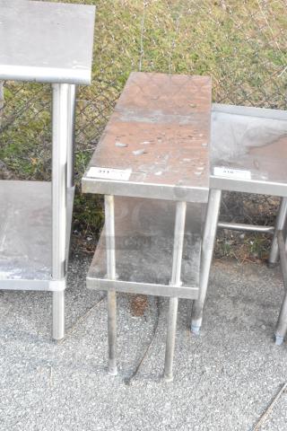Stainless steel 2 tier over shelf, sturdy construction, visibly worn with surface stains. Label reading "311" attached.