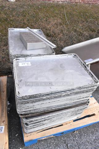 Stack of 102 metal full-size baking pans on wooden pallets. Visible wear; labels indicate auction item number 315.