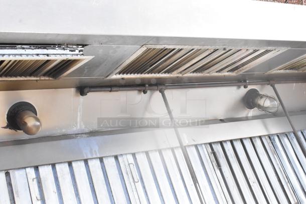 9.5' stainless steel return air grease hood with filters and lights, visible wear, industrial use.