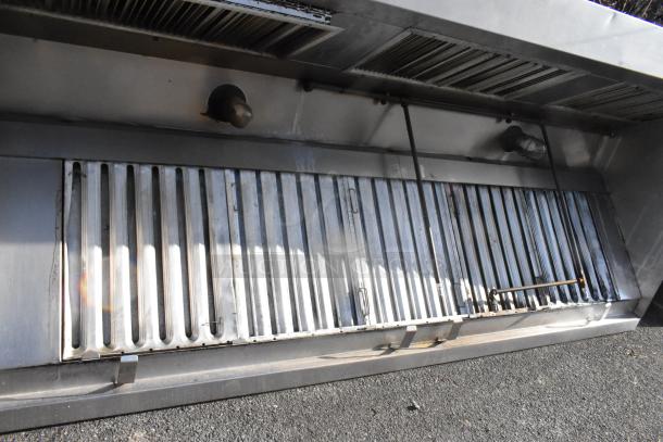 9.5' stainless steel return air grease hood with filters and lights, showing slight wear, essential for kitchen ventilation.