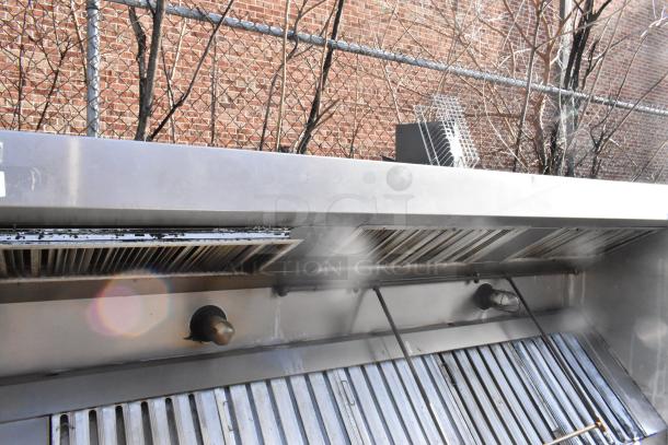 9.5' stainless steel return air grease hood with filters and lights, outdoor setup, used condition, features durable construction.