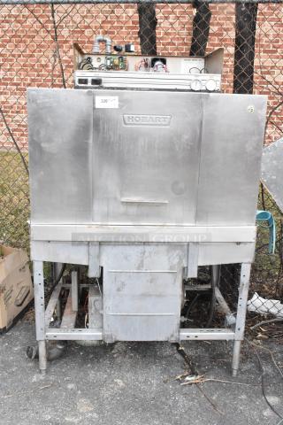 Hobart C44A stainless steel commercial conveyor dishwasher, floor style, 480 volts, 3 phase, visible wear, needs cleaning.