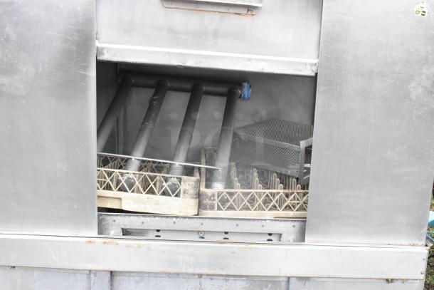 Hobart C44A stainless steel commercial conveyor dishwasher in used condition, visible internal racks and spray arms.