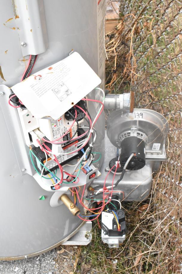 2024 AO Smith BTL-199 water heater, metal, natural gas powered, automatic storage, exposed wiring, outdoor setting.