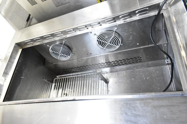 2022 Atosa MSF3610GR stainless steel commercial prep table interior view, dual fans, grid shelf, sturdy construction.