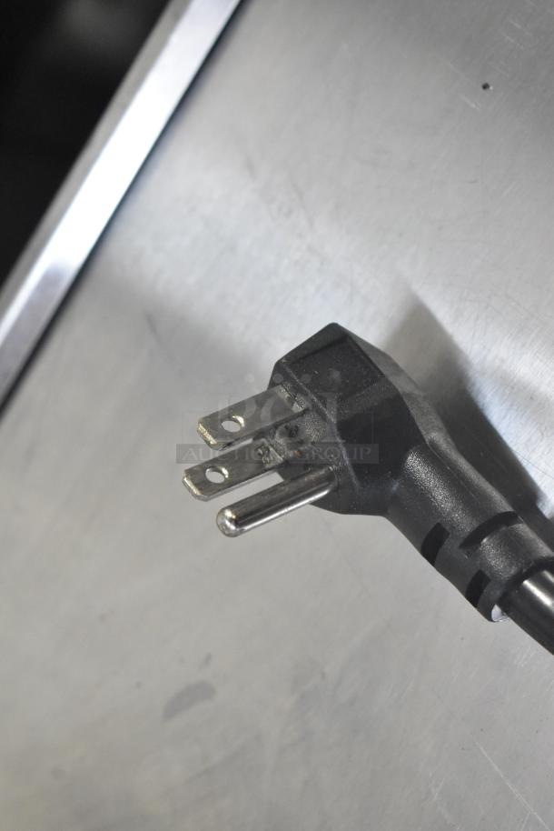 Close-up of a 115V power plug for the Atosa MSF3610GR stainless steel commercial prep table on casters.