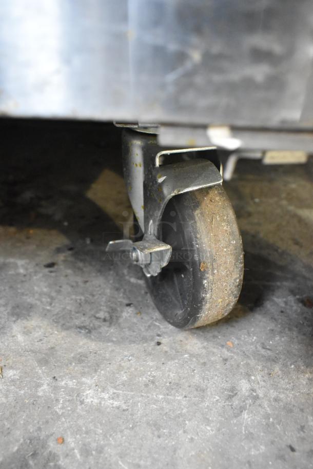2022 Atosa MSF3610GR stainless steel commercial prep table on casters, shown detail of a caster wheel.