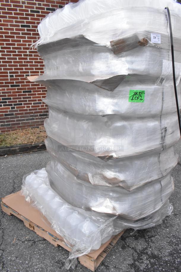 Pallet of new, scratch and dent 1-gallon translucent HDPE milk jugs with handles, wrapped and stacked for auction.
