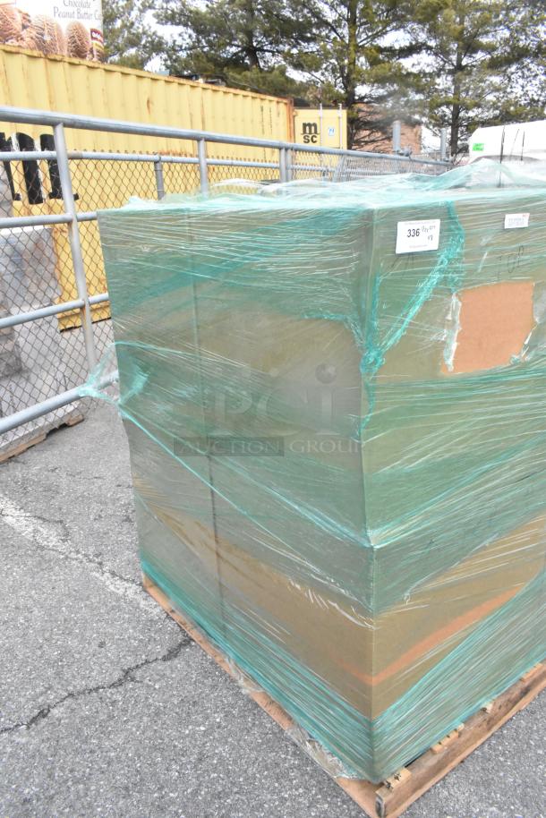 Pallet of boxed Martha Stewart Taytum saddle brown faux leather swivel chairs wrapped in green plastic film, brand new.