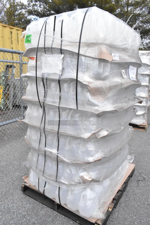 Pallet of brand new 1-gallon translucent HDPE milk jugs with handles, wrapped in plastic, noted as "scratch and dent."