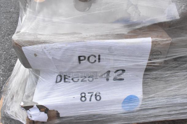 Plastic-wrapped pallet with label showing "PCI DEC25-12 876." Contains 10 scratch and dent items, including jars and tabletop.