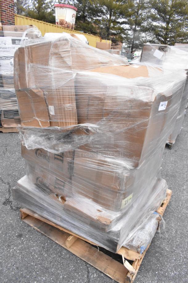 Pallet of new "scratch and dent" items wrapped in plastic, including boxed goods. Labels indicate mixed inventory.