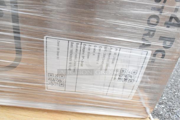 Shrink-wrapped pallet of new items including 70 qt ultrastorage boxes and bar sink. Visible label notes operator and date.