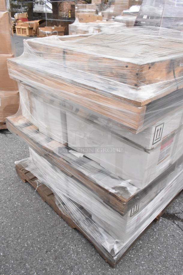 Stacked pallets wrapped in plastic, containing 24 new scratch and dent items including Pink Suds Powdered Hand Dishwash.