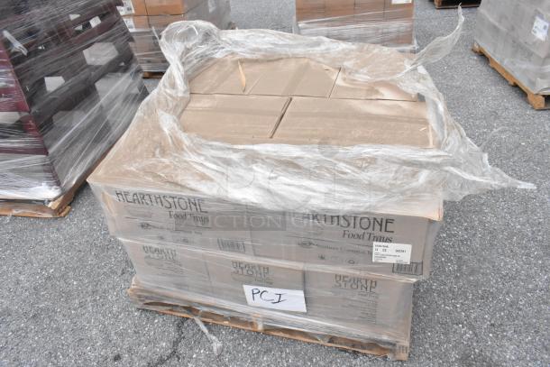 14 brand new Hearth Stone food trays, scratch and dent, in unopened boxes on a pallet. Labels indicate "14 CS" and model details.