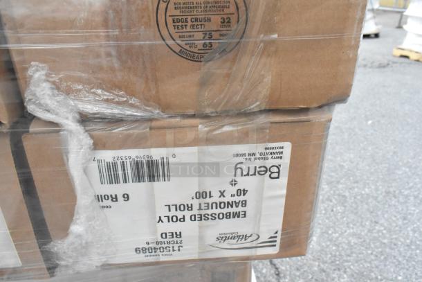 Boxes labeled "Berry" with barcodes, markings for embossed poly banquette roll, and edge crush test information; part of a new scratch and dent auction lot.