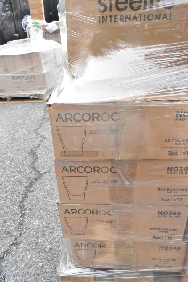 Boxes of Arcoroc NO388 Skyscraper Rocks Glasses wrapped in plastic, featuring 7oz capacity, part of a scratch and dent auction lot.