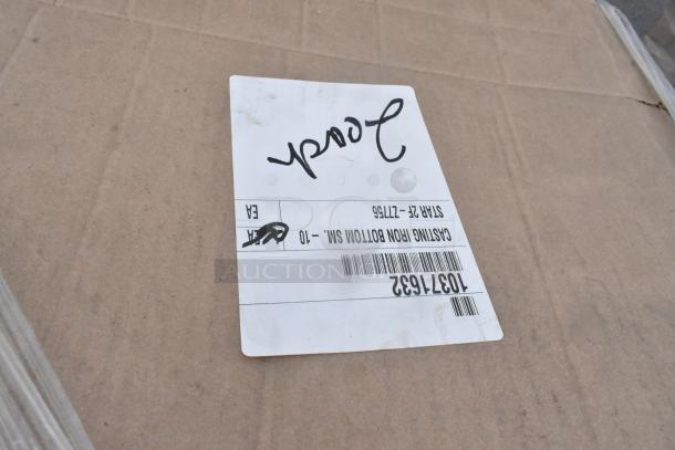 Cardboard box with label reading "Casting Iron Bottom" and number 10371632, part of auction items including Steelite and Arcoroc products.