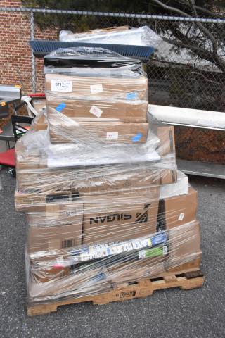 Pallet with 42 new scratch and dent items, wrapped in plastic. Contains cutting board, fan motor, glasses. Various boxes visible.