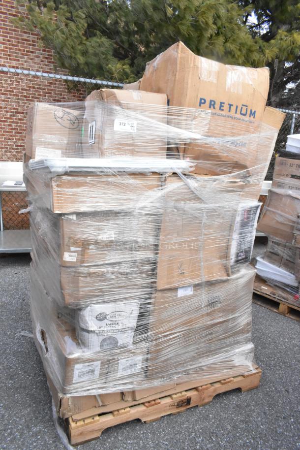 Pallet of wrapped boxes labeled "PRETIUM" containing 31 new scratch-and-dent items, including pipe clamps and mixing glasses.
