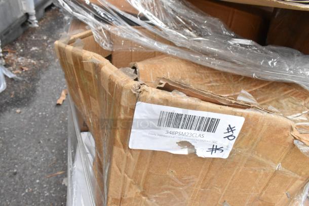 Cardboard box with visible scratch and dent damage, labeled "348PSM23CLAS Clutch Assembly," wrapped in plastic.