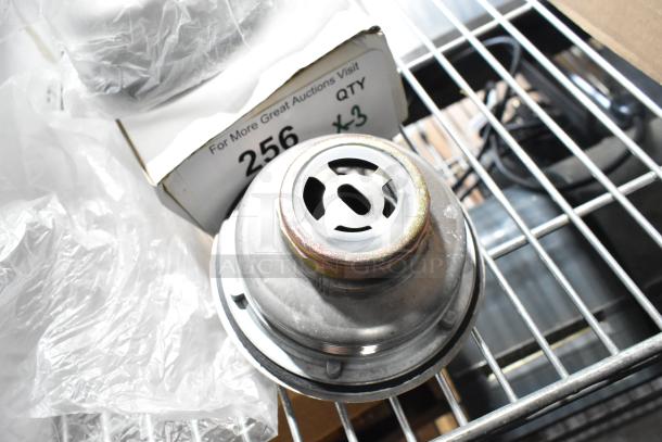 3 new Regency 600DB35 basket drains with strainer, 3 1/2", 1 1/2" IPS. Slight scratches and dents visible. Quantity 3.