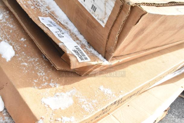 Cardboard boxes labeled with product codes, partially covered in snow, containing new scratch and dent items.
