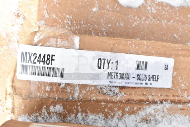 Label on a snow-dusted package showing MX2448F MetroMax i Solid Shelf, QTY: 1, Made in USA.