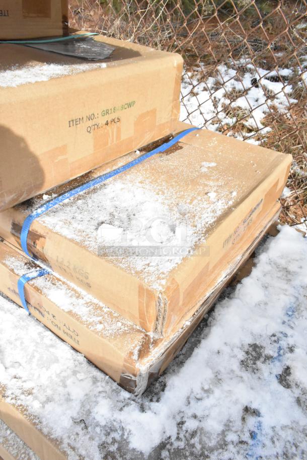 Cardboard boxes containing scratch and dent items, labeled with item numbers GR1848CWP and quantity of 4 pieces, snow-covered.
