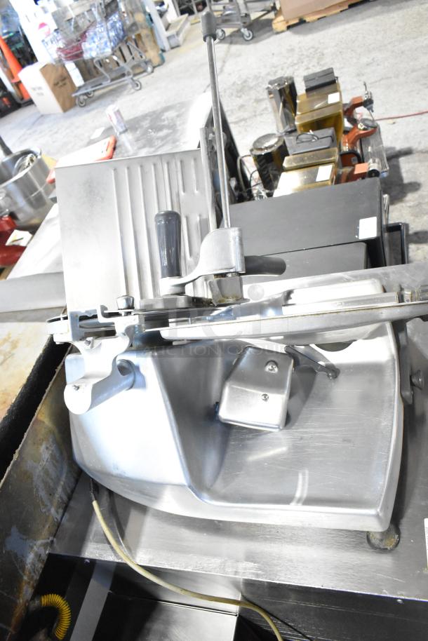 Hobart 2612 stainless steel commercial meat slicer with blade sharpener, 115V, 1 phase, tested and working, includes handle and safety features.